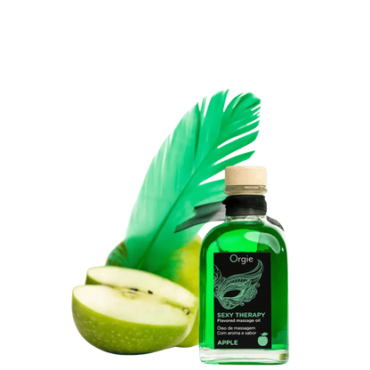 Huile de massage embrassable Sexy Therapy Pomme, de couleur verte, accompagnée d'une plume verte et d'une pomme verte coupée en deux.