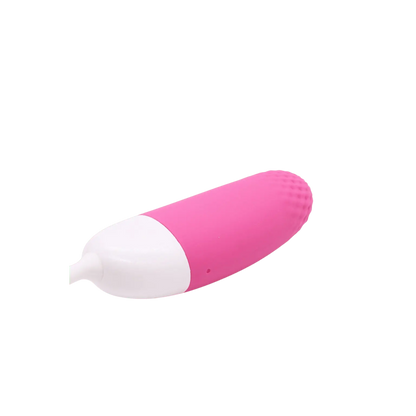 Vue latérale de l'œuf vibrant Magic Vini en rose et blanc, disponible chez Oh My God'Z. Sextoy ergonomique offrant des vibrations puissantes et une texture en silicone doux, idéal pour des moments intimes en solo ou en couple.