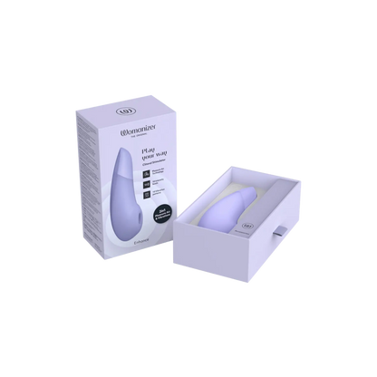 Le Womanizer Enhance en version lavande dans son coffret de luxe, stimulateur clitoridien premium 2-en-1 par pulsation et vibration, vendu par la boutique Oh My God'Z.