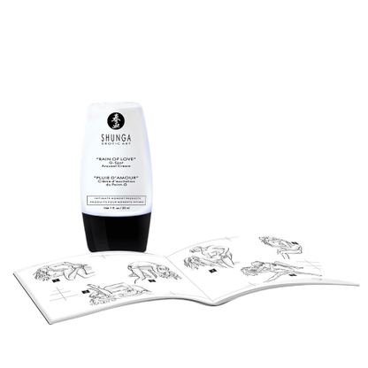 Flacon de creme d'excitation point G Shunga blanc et noir pose pres d'un livret de positions - Oh My God'Z