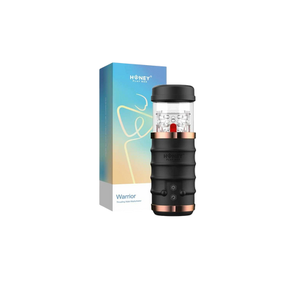 Masturbateur automatique Warrior noir et cuivre avec manchon transparent, présenté avec son packaging - Oh My God'Z